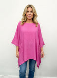 A plus size casual top in fuchsia color with front pockets.