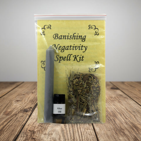 Banishing Negativity Spell Kit with candle, herbs, and oil on a white background