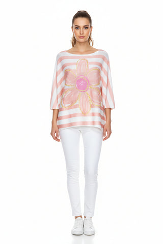 Pink and white striped top with a floral design on a hanger against a white background