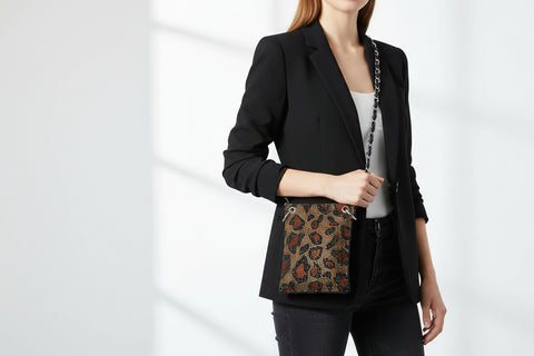 Leopard print handbag with chain strap on a white background