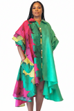 Colorful traditional outfit with a green and pink patterned top and skirt on a white background
