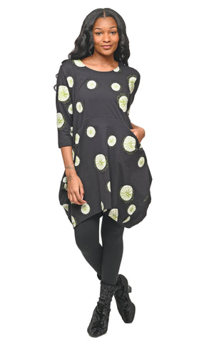 Woman wearing a black dress with white floral patterns on a white background