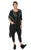 Woman wearing a black outfit with abstract patterns on a white background