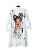 White shirt with a cartoon character and floral design on a hanger