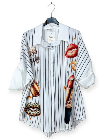 Striped shirt with cosmetic-themed graphics on a hanger against a white background