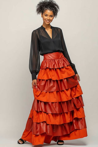 Woman wearing a black top and red tiered skirt on a white background