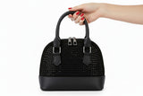 Black studded handbag on a white background