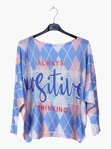 Blue and pink patterned shirt with 'Always Positive Thinking' text on a hanger
