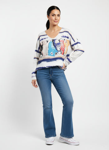 Colorful sweater with shoe design on a hanger against a white background