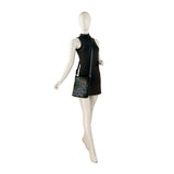 Mannequin wearing a black dress with a colorful peacock feather design on a white background
