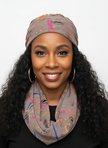 Mannequin head with a colorful scarf on a white surface
