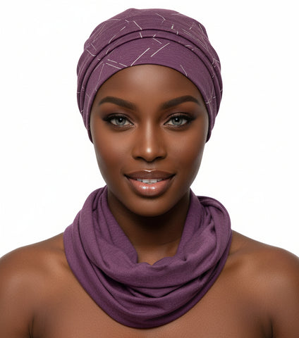 Mannequin head wearing a purple headscarf and scarf on a black background
