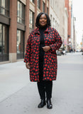 Black fabric with red lip prints on a geometric patterned floor