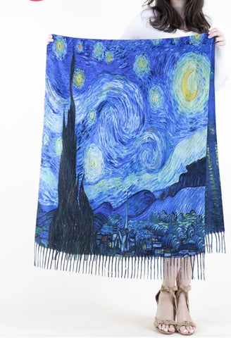Person holding a scarf with a 'Starry Night' design
