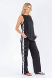 Black sleeveless top and pants with white stripes on a white background