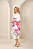 Woman wearing a floral dress with a white background