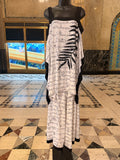 Mannequin wearing a black and white 2 piece pants set with black patterns in an elegant interior setting