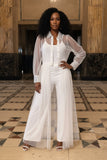 White tulle dress on a mannequin against a decorative wall with geometric patterns