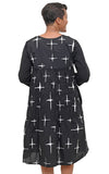 Black dress with white abstract patterns worn by a person on a white background