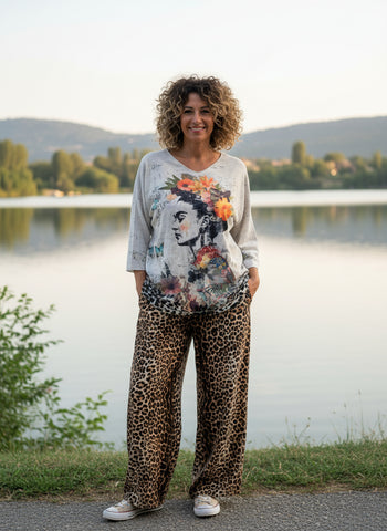 Floral and leopard Frida Khalo print top on a hanger against a white background