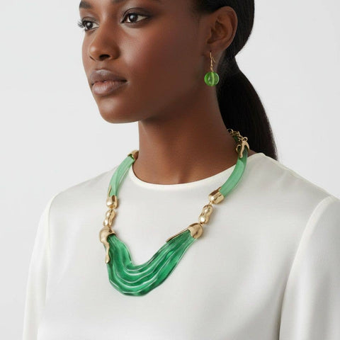 Woman wearing a green necklace and earrings on a white background