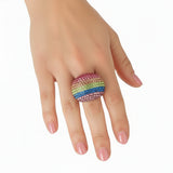 Hand wearing a colorful beaded ring on a white background