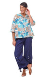 Woman wearing a patterned shirt and blue pants on a white background