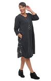 Woman wearing a black dress with white patterns on a white background