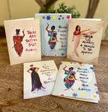 Set of five motivational greeting cards with illustrated women on a wooden surface.