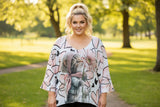 Floral and heart cat patterned blouse on a hanger with a white background