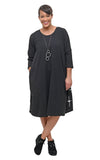 Woman wearing a black dress with long sleeves on a white background